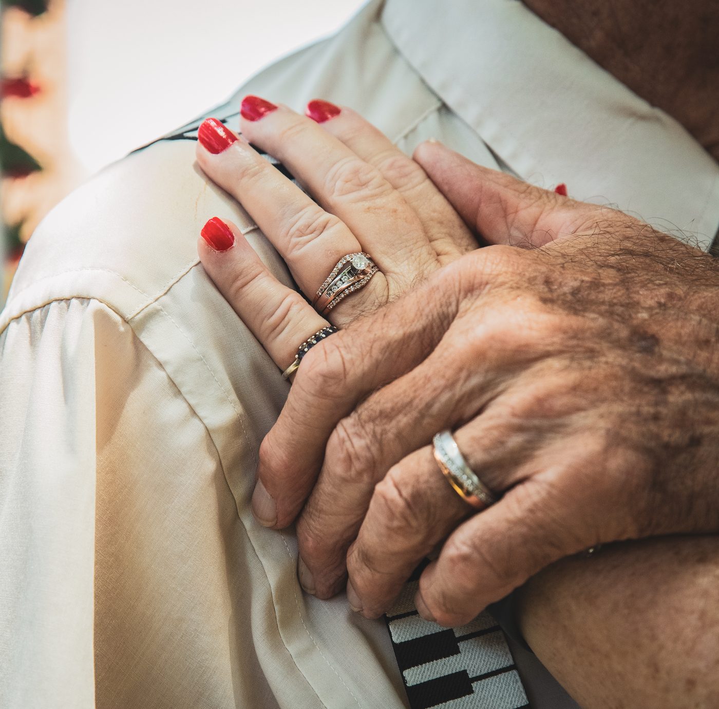 Close-up of a couple's hands with wedding rings