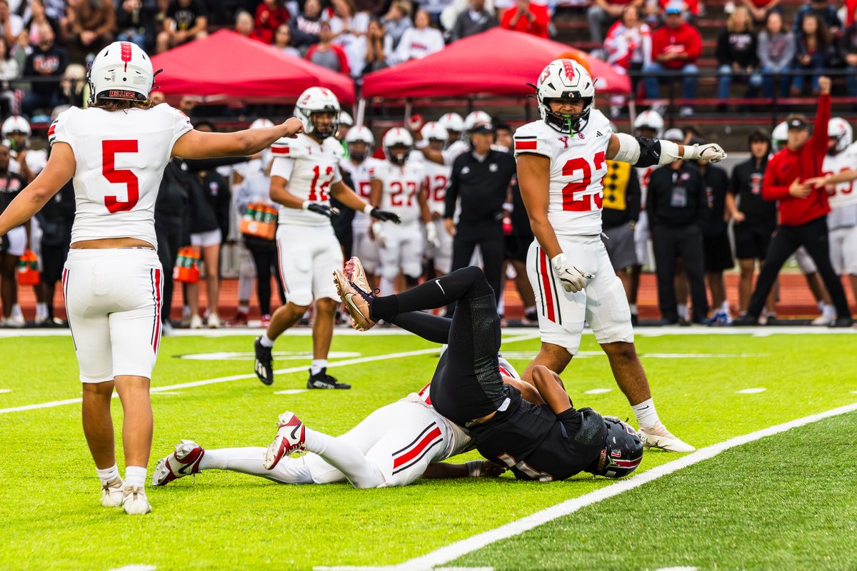 Tackle at the goal line with teammates celebrating