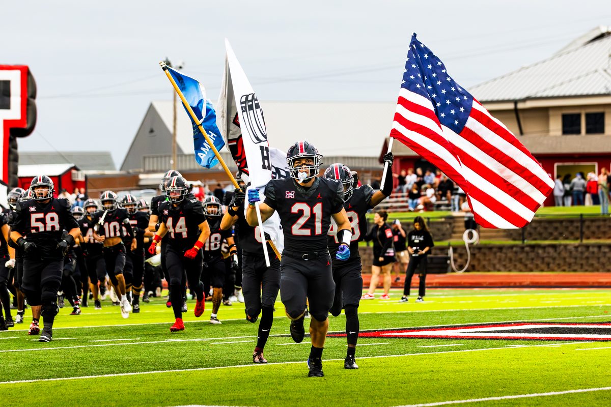 Player carrying the team flag onto the field